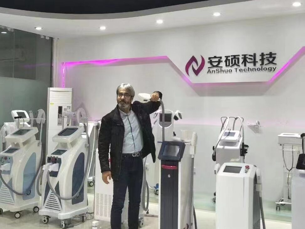 Client standing in front of several IPL Laser machines